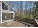 Wooden deck and gray siding provide a view of the wooded backyard at 566 Hickory Hills Ct, Stone Mountain, GA 30083