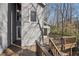 Exterior shot of a wood deck with gray house in the background and stairs leading down at 566 Hickory Hills Ct, Stone Mountain, GA 30083