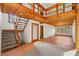 Bright foyer features wood ceiling, stairway to loft, and tile flooring leading to the living room at 566 Hickory Hills Ct, Stone Mountain, GA 30083