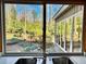 A sink view captures the wooded backyard from the kitchen at 566 Hickory Hills Ct, Stone Mountain, GA 30083