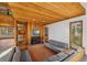 Living room offering wood paneled accent walls, fireplace, and a glimpse of the outdoor scenery at 566 Hickory Hills Ct, Stone Mountain, GA 30083