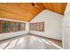 Bright living room with wood plank ceiling and large windows overlooking wooded views at 566 Hickory Hills Ct, Stone Mountain, GA 30083