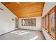 Bright living room with wood plank ceiling, natural light, and scenic wooded views at 566 Hickory Hills Ct, Stone Mountain, GA 30083