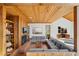 Wood-paneled living room features a fireplace, built-in bookshelves, and recessed seating at 566 Hickory Hills Ct, Stone Mountain, GA 30083