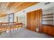 View of lofted living space with unique wood walls, built in shelving, and carpeting at 566 Hickory Hills Ct, Stone Mountain, GA 30083