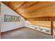 Loft area with wood ceiling, built-in shelving, a view of the outside, and a neutral-colored carpet at 566 Hickory Hills Ct, Stone Mountain, GA 30083