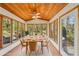 Staged sunroom filled with natural light, thanks to many surrounding windows and door leading to the backyard at 566 Hickory Hills Ct, Stone Mountain, GA 30083