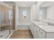 Bathroom featuring double vanity, a large tub, and tiled shower with glass door at 98 Hampton Ter, Dallas, GA 30157