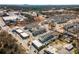 Aerial view of a vibrant community featuring modern townhomes, shops, and tree-lined streets at 108 Brighton Blvd, Woodstock, GA 30188