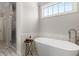 Relaxing soaking tub positioned next to a shower, complemented by board and batten and lots of natural light at 108 Brighton Blvd, Woodstock, GA 30188