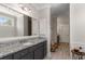 Granite counters accent this bathroom with a large mirror, cabinets, and bench seating that is adjacent to the hall at 108 Brighton Blvd, Woodstock, GA 30188