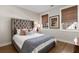 Bedroom with a neutral color palette, textured headboard, and windows with natural light shining in the space at 108 Brighton Blvd, Woodstock, GA 30188