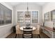 Cozy dining area with a round table and three windows at 108 Brighton Blvd, Woodstock, GA 30188