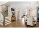 Open-concept dining room with modern light fixture and hardwood floors at 108 Brighton Blvd, Woodstock, GA 30188