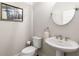 Stylish powder room with pedestal sink and decorative mirror at 108 Brighton Blvd, Woodstock, GA 30188