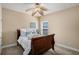 Cozy bedroom with neutral tones, soft carpet, and a ceiling fan for added comfort at 1760 Carissa Dr, Conyers, GA 30094