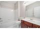 Well-lit bathroom featuring a vanity with a white countertop, a toilet, and a bathtub with shower at 214 White Cloud Run, Canton, GA 30114