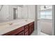 Bathroom featuring double sink vanity with gold fixtures and views of the bedroom at 214 White Cloud Run, Canton, GA 30114