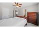 Neutral bedroom with ceiling fan, dresser and views to the ensuite bathroom at 214 White Cloud Run, Canton, GA 30114