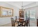 Elegant dining room with chandelier lighting, dining table set for six, and decor mirror, and large window at 214 White Cloud Run, Canton, GA 30114