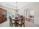 Classic dining room featuring a wooden table with seating for six, traditional chandelier, and elegant accents at 214 White Cloud Run, Canton, GA 30114