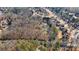 Aerial view of the home's secluded location amongst a lush green forest and neighboring homes at 2499 E Maddox Rd, Buford, GA 30519