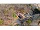 Aerial view of home surrounded by trees, showcasing the driveway and detached garage at 2499 E Maddox Rd, Buford, GA 30519