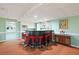 Basement bar area features seating for six, built-in storage and adjacent recreation space at 2499 E Maddox Rd, Buford, GA 30519