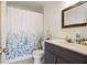 Bathroom with vanity, framed mirror, toilet, and shower with floral curtain at 2499 E Maddox Rd, Buford, GA 30519