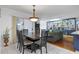 Dining area featuring a decorative light fixture and built-in shelving in an open layout at 2499 E Maddox Rd, Buford, GA 30519