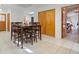 Bright dining room with tile floors, wood dining table and chairs, closet, and access to other rooms at 2499 E Maddox Rd, Buford, GA 30519