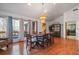 Open dining room with hardwood floors, a chandelier, and large bright windows at 2499 E Maddox Rd, Buford, GA 30519