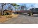 Ranch-style home showcasing a porte-cochere, mature landscaping, and a circular driveway at 2499 E Maddox Rd, Buford, GA 30519