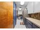 Long galley kitchen with stainless steel refrigerator and two-tone cabinets at 2499 E Maddox Rd, Buford, GA 30519