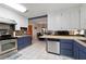 Kitchen with stainless steel appliances, two-tone cabinets, and breakfast bar overlooking dining area at 2499 E Maddox Rd, Buford, GA 30519