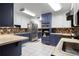 Well-lit kitchen with two-tone cabinets, stainless steel appliances, and mosaic tile backsplash at 2499 E Maddox Rd, Buford, GA 30519