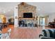 Bright living room showcasing a stone fireplace and open layout with dining area at 2499 E Maddox Rd, Buford, GA 30519