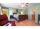 Main bedroom features a ceiling fan, light green walls, wood floors, and a red chair at 2499 E Maddox Rd, Buford, GA 30519