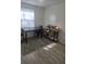 Cozy dining area with wood-look flooring, a dark table and chairs, and natural lighting at 2540 Marsha Cir, Cumming, GA 30041