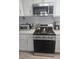 A modern stainless steel oven and microwave sit on a counter with white cabinets at 2540 Marsha Cir, Cumming, GA 30041