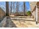 Large flagstone backyard featuring mature trees and a storage shed, perfect for outdoor activities at 3640 Hickory Se Cir, Smyrna, GA 30080