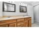 Bathroom featuring dual sinks with wood vanity, and framed mirrors at 3640 Hickory Se Cir, Smyrna, GA 30080