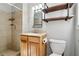 Bathroom with a stand up shower, wood cabinet and unique shelving unit at 3640 Hickory Se Cir, Smyrna, GA 30080