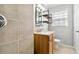 Bathroom featuring a shower, wood vanity, and modern industrial-style shelving at 3640 Hickory Se Cir, Smyrna, GA 30080