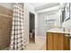 Bathroom showcasing a shower and a wood vanity with a sink and a view into a second bathroom at 3640 Hickory Se Cir, Smyrna, GA 30080