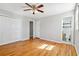 Bright bedroom featuring hardwood floors, ceiling fan, closet and attached bathroom at 3640 Hickory Se Cir, Smyrna, GA 30080