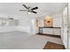 Spacious living room featuring a ceiling fan, white walls, and built-in shelving along the wall at 3640 Hickory Se Cir, Smyrna, GA 30080