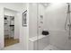 Contemporary bathroom with glass shower, tiled walls, and a view to the walk-in closet at 201 New St # 2301, Decatur, GA 30030