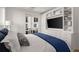 Beautiful bedroom featuring a TV, a white and blue comforter, and sliding doors to a balcony at 201 New St # 2301, Decatur, GA 30030