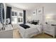 Beautiful bedroom with ample light, modern decor, and stylish, contrasting black curtains at 201 New St # 2301, Decatur, GA 30030